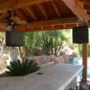 Outdoor living area with televisions